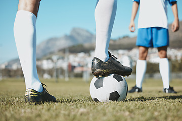 Image showing Soccer, legs and foot on ball for match, game or start on the green grass field in nature outdoors. Feet of sports player on football for competition, beginning or getting ready in sport tournament