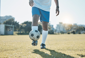 Image showing Training, field and legs of a man with a football for a game, fitness and learning sports. Grass, workout and feet of an athlete for a goal, exercise and playing professional soccer in nature