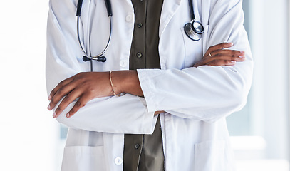 Image showing Hands, doctor and arms crossed in hospital for clinic services, consultation and medical support. Closeup of cardiology expert, therapist and healthcare worker ready for surgery consulting with trust