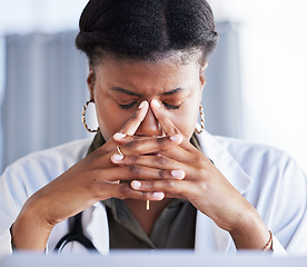 Image showing Tired doctor, African woman and headache at desk, clinic office or stress with thinking in workplace. Overworked medic, fatigue and burnout in hospital, worry or anxiety for mental health in wellness