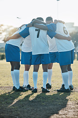 Image showing Soccer, support or team in a huddle for motivation, goals or group mission on a field for a sports game. Unity, stadium or football players planning a strategy, exercise or training for fitness match