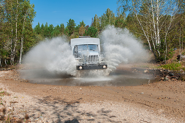 Image showing truck passes through a puddle