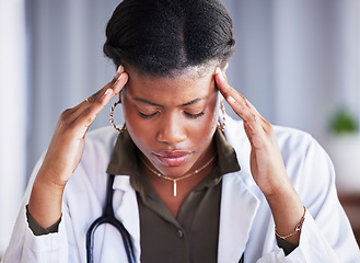 Image showing Tired doctor, black woman and stress with headache at clinic, office and thinking with pain at job. Overworked medic, fatigue and burnout in hospital, worry or anxiety for mental health in wellness