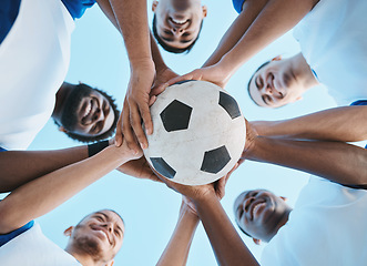 Image showing Soccer ball, support or team in a huddle for motivation, goals or group mission for a sports game or match. Smile, sky or low angle of happy football players in exercise, workout or fitness training