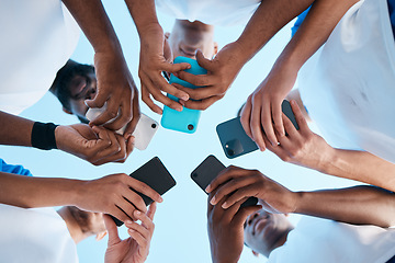 Image showing Hands, phone and app with people in a huddle or circle for communication or connectivity. Mobile, social media or information sharing with a group of men networking together closeup from below