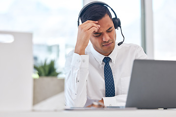 Image showing Call center, working and man with a headache or businessman in customer service with stress, burnout or fatigue. Tired, exhausted or consultant in office with a migraine, pain or anxiety from crm