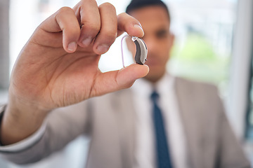 Image showing Hand, business man and hearing aid for ear, sound amplifier and audio communication in company office. Professional, person with a disability and deaf with implant technology to help with listening