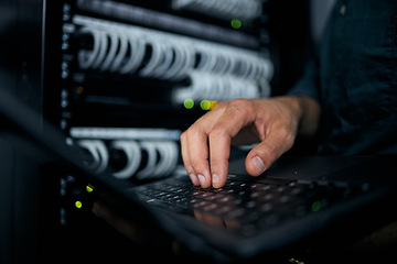 Image showing Hands, laptop and typing in server room, man and inspection with coding, analysis and night for programming. Information technology expert, computer and keyboard for database, solution or maintenance