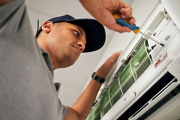 Image showing Maintenance, air conditioner and man with screwdriver for problem solving on machine from below. Aircon, ac repair and handyman service with technician, electrician or contractor work on ventilation