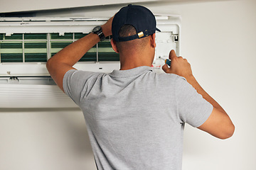 Image showing Maintenance, air conditioner and man with screwdriver for problem solving on machine from back. Aircon, ac repair and handyman service with technician, electrician or contractor work on ventilation.