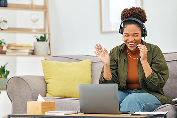 Image showing Video call, wave and woman on sofa with laptop, headphones and smile in living room home office. Hello, webinar and online meeting with happy virtual assistant on couch for freelance remote work job.