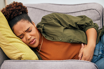 Image showing Sick woman, stomach pain and problem on sofa for ibs, health risk or nausea of gastric bloating, period cramps or virus. Black female person, menstruation or stress of constipation from endometriosis