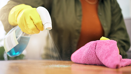 Image showing Woman, hands and spray on table with cloth for hygiene, bacteria or germ removal at home. Closeup of female person, housekeeper or maid wiping furniture in domestic service or disinfection on surface