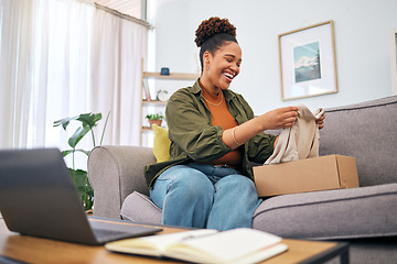 Image showing Online shopping, woman on sofa with package and smile, discount fashion retail and laptop in living room. Delivery of clothes, ecommerce and happy person on couch with box from website sale or deal.