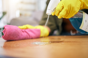 Image showing Person, hands and spray on table with cloth for hygiene, bacteria or germ removal at home. Closeup of cleaner, housekeeper or maid wiping furniture in domestic service or disinfection on desk surface