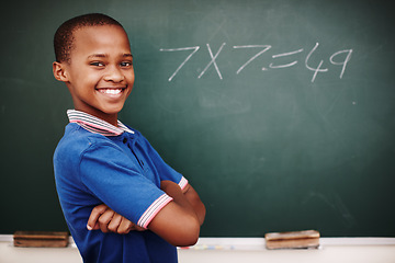 Image showing Im getting the hang of this. A proud young schoolboy standing with his arms crossed after doing a sum correctly at the blackboard.