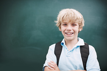 Image showing Super happy to be at school. A young schoolboy crossing his arms while standing alongside copyspace at a blackboard.