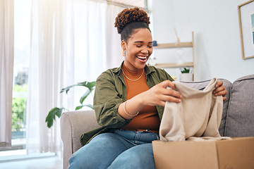 Image showing Online shopping, happy woman on sofa with package unboxing, discount fashion retail gift in living room. Delivery of designer clothes, ecommerce and girl on couch with box from website sale or deal.