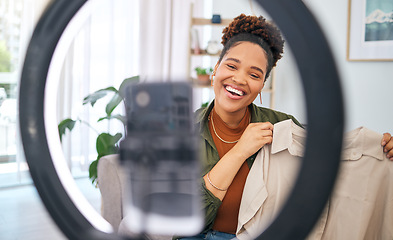 Image showing Fashion, social media and a black woman content creator unboxing a clothes outfit in her home. Live streaming, brand deal and a happy female influencer recording a broadcast for subscription service