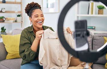 Image showing Fashion, live streaming and a black woman content creator unboxing a clothes outfit in her home. Social media, brand deal and a happy female influencer recording a broadcast for subscription service