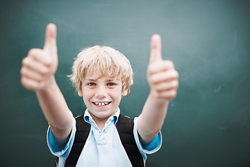 Image showing Awesome. A young schoolboy giving you a thumbs up while standing alongside copyspace at a blackboard.