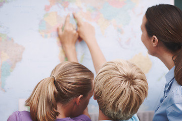 Image showing Turkey. Two excited schoolchildren pointing at a world map as their teacher looks on.