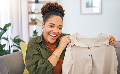 Image showing Fashion, influencer and a black woman streamer unboxing a clothes outfit in her home. Social media, brand deal and a happy female content creator recording a live broadcast for subscription service