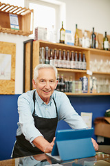 Image showing Living the small business dream. Shot of a senior man working in a coffee shop.