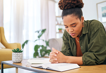 Image showing Young woman, bible and prayer in home, desk and mindfulness for faith, religion and reading with hope for future. African lady, praying hands and study holy book for peace, meditation or worship God