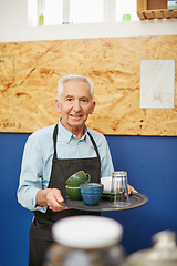 Image showing Busy day at the coffee shop. Shot of a senior man working in a coffee shop.