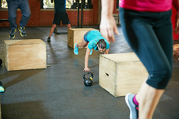 Image showing Push harder, get stronger. Shot of a young woman doing push ups during her workout at the gym.