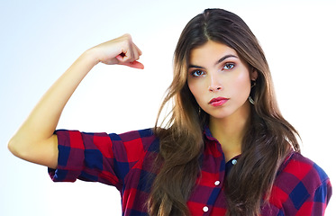 Image showing Im not just a woman, Im a strong woman. Cropped shot of a young woman flexing her muscles against a white background.