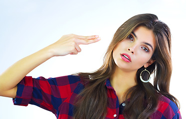 Image showing Im not impressed...Shot of a young woman posing against a white background.