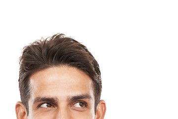 Image showing Intrigued by your copyspace. Cropped shot of a young mans face looking sideways at copyspace.