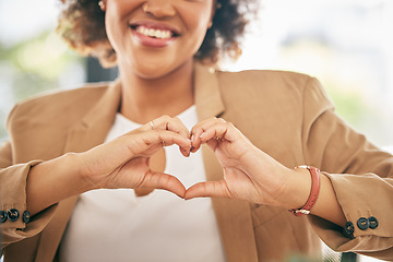 Image showing Hands, heart and business woman with love emoji for care, kindness and like in office. Closeup of happy female worker with finger shape for thank you, trust and sign of hope, support icon and peace