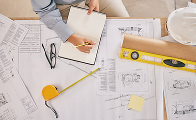 Image showing Above, blueprint and hands with notes for architecture, construction planning and building design. Desk, architect and writing a goal for infrastructure ideas, creativity and a contractor strategy