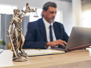 Image showing Justice, statue and man in office with laptop at law firm desk, online research for court advice and senior lawyer. Judge, attorney or legal consultant in human rights, computer and internet search.