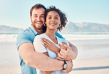 Image showing Beach, love and portrait of couple hugging in nature, holiday or romantic outdoor date together at the ocean, sea or sand. Happy, smile and people in a hug, embrace or happiness on anniversary