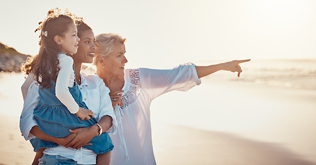 Image showing Family, summer and vacation while pointing at the beach on holiday or adventure together. Women or a mother and grandmother with a girl kid outdoor for fun, happiness and learning about nature