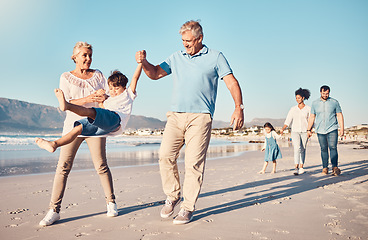 Image showing Swinging, grandparents and a child walking on the beach on a family vacation, holiday or adventure in summer. Young boy kid holding hands with a senior man and woman outdoor with fun energy or game