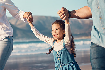 Image showing Happy, excited and a child running at the beach on a family vacation, holiday or adventure in summer. Young girl kid holding hands with parents outdoor with fun energy, happiness and love at sea