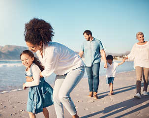 Image showing Happy, child and a mother running at the beach on a family vacation, holiday or adventure in summer. Young girl kid playing with a woman outdoor with fun energy, happiness and love by the ocean