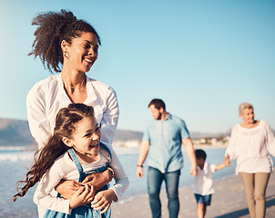 Image showing Mother, child and playing outdoor at the beach on a family vacation, holiday or adventure in summer. Excited young girl kid and a woman with fun energy, happiness and love or quality time at sea