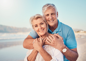 Image showing Beach, love and portrait of senior couple hugging in nature, holiday or romantic outdoor date together at the ocean, sea or sand. Happy, smile and people in a hug, embrace or happiness on anniversary