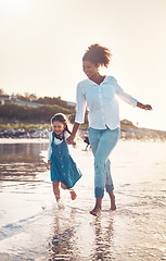 Image showing Fun, child and a mother running at the beach on a family vacation, holiday or adventure in summer. Young girl kid holding hands with woman outdoor with fun energy, happiness and love at sunset ocean