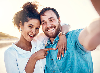 Image showing Selfie, holiday and happy couple celebrate engagement, marriage and beach memory on social media. Digital photography, man and woman relax on ocean vacation together with smile, love and wedding ring