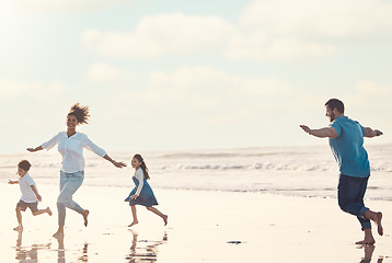 Image showing Mother, father and children on the beach to dance together while outdoor for travel or vacation in summer. Sunset, family or children and siblings having fun with parents on the coast by the ocean