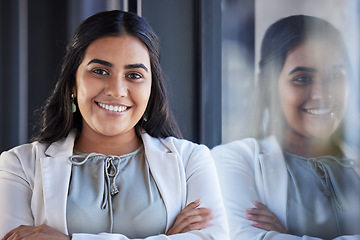 Image showing Business woman, smile and happy portrait in an office with arms crossed and career pride. Face of a young female entrepreneur with confidence, positive mindset and commitment to corporate startup