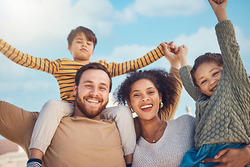 Image showing Portrait, motivation and piggyback with a family cheering together against a blue sky. Diversity, love or smile with happy parents and children in the garden of their home for trust or support