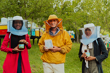 Image showing Portrait of Arab investors with a beekeeper in a large honey production farm